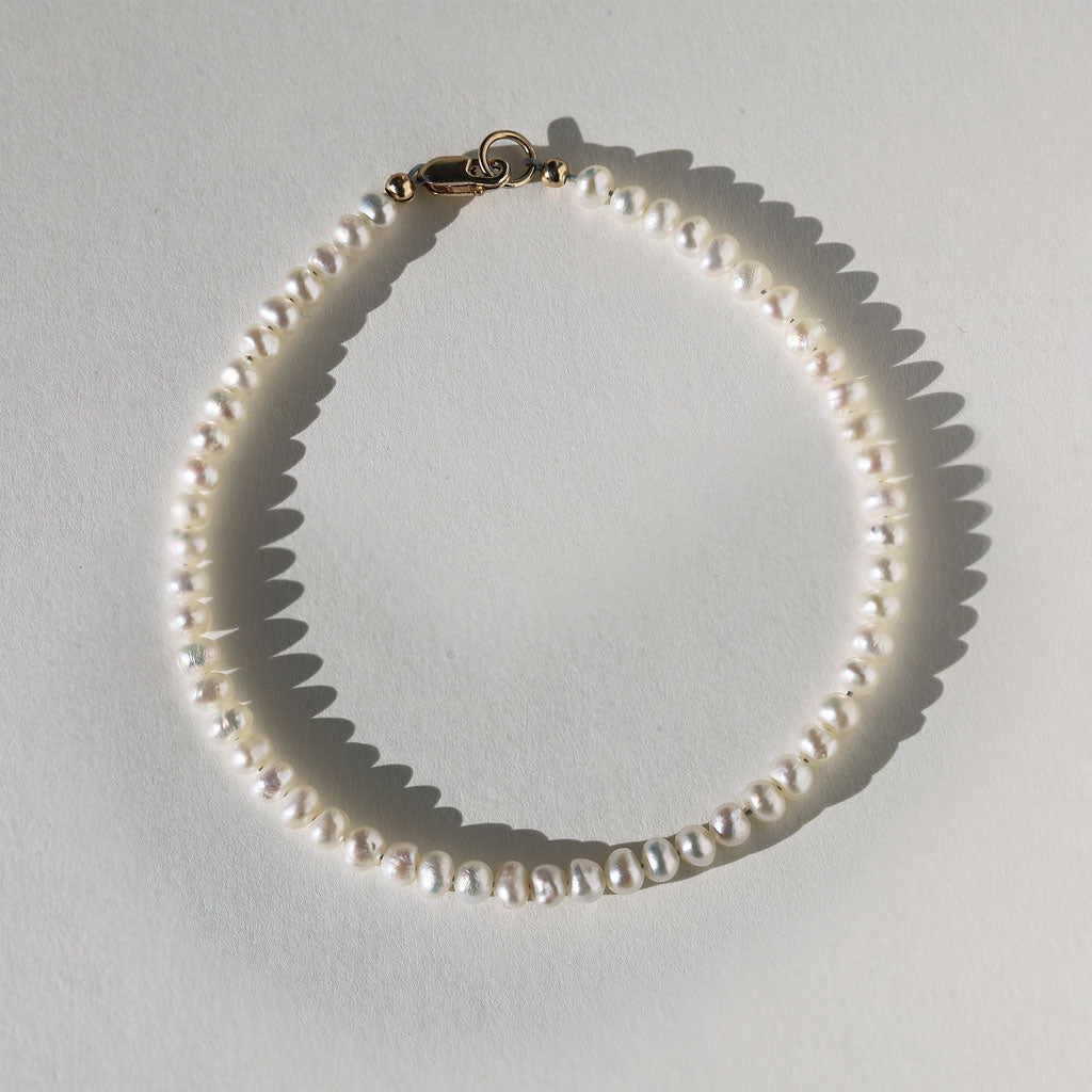 tiny white pearl bracelet with gold clasp