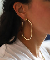 ear with extra large gold irregular hoop earring