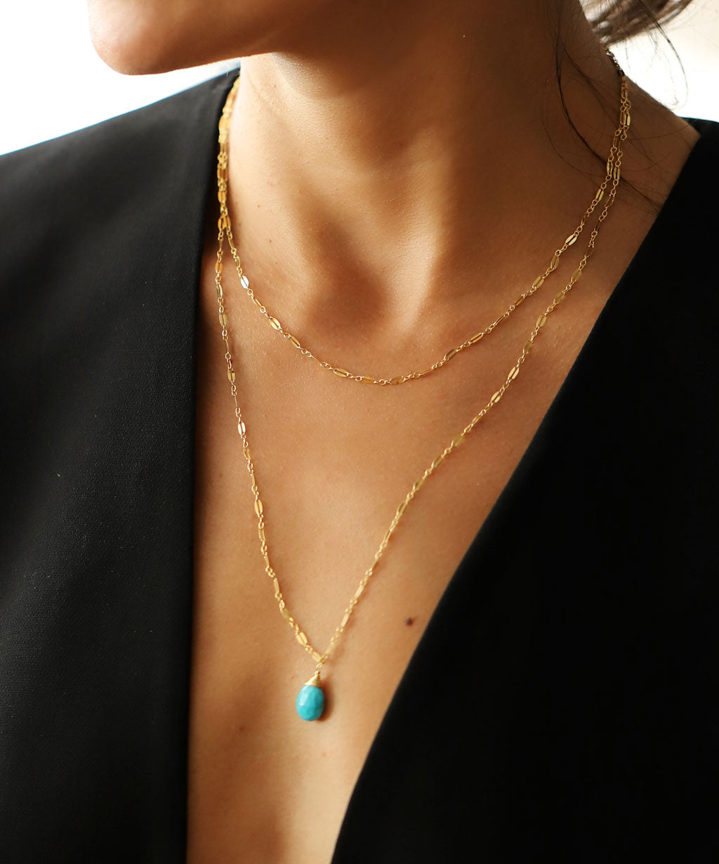 neckline with delicate long and short double strand turquoise necklace