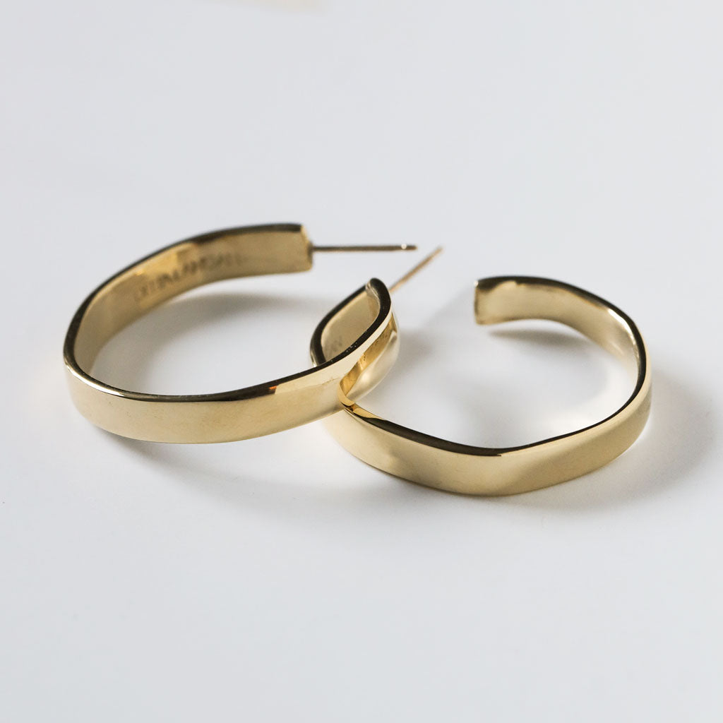 side view of flat medium sized gold hoop earring