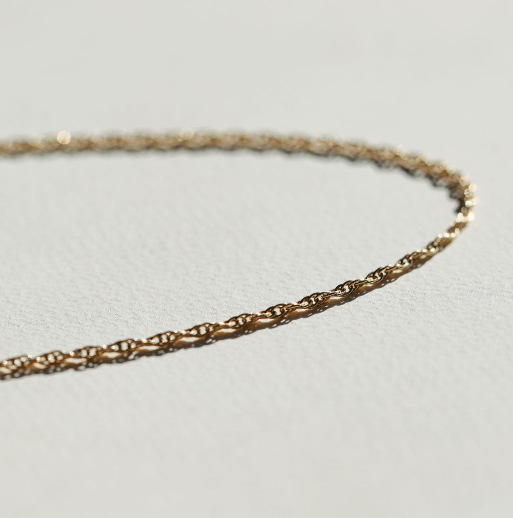 still life side view of gold rope chain