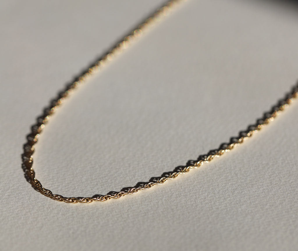 still life side view of gold rope chain