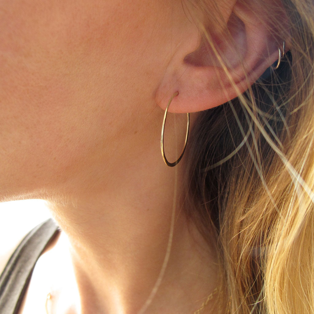 1" diameter thin gold hoop earrings on ear