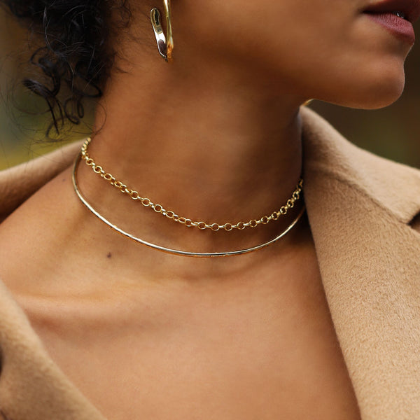 closeup of neck with gold chain choker and gold wire choker