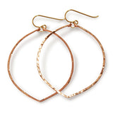 rose gold filled fig hoop earrings on a white surface partially reflecting light