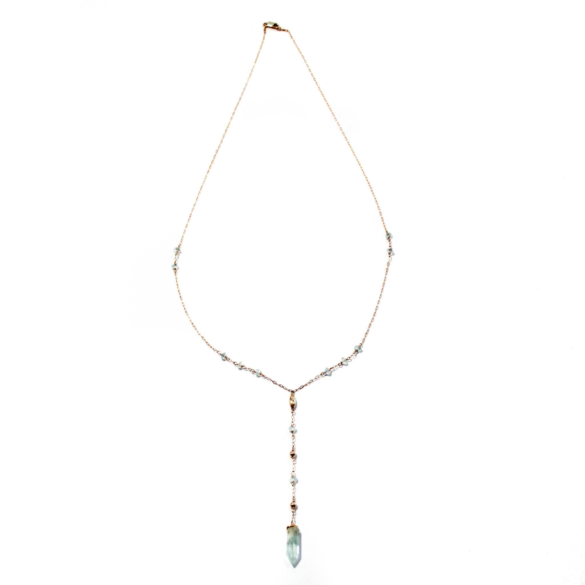 14k gold filled aquamarine y gemstone necklace on a white surface