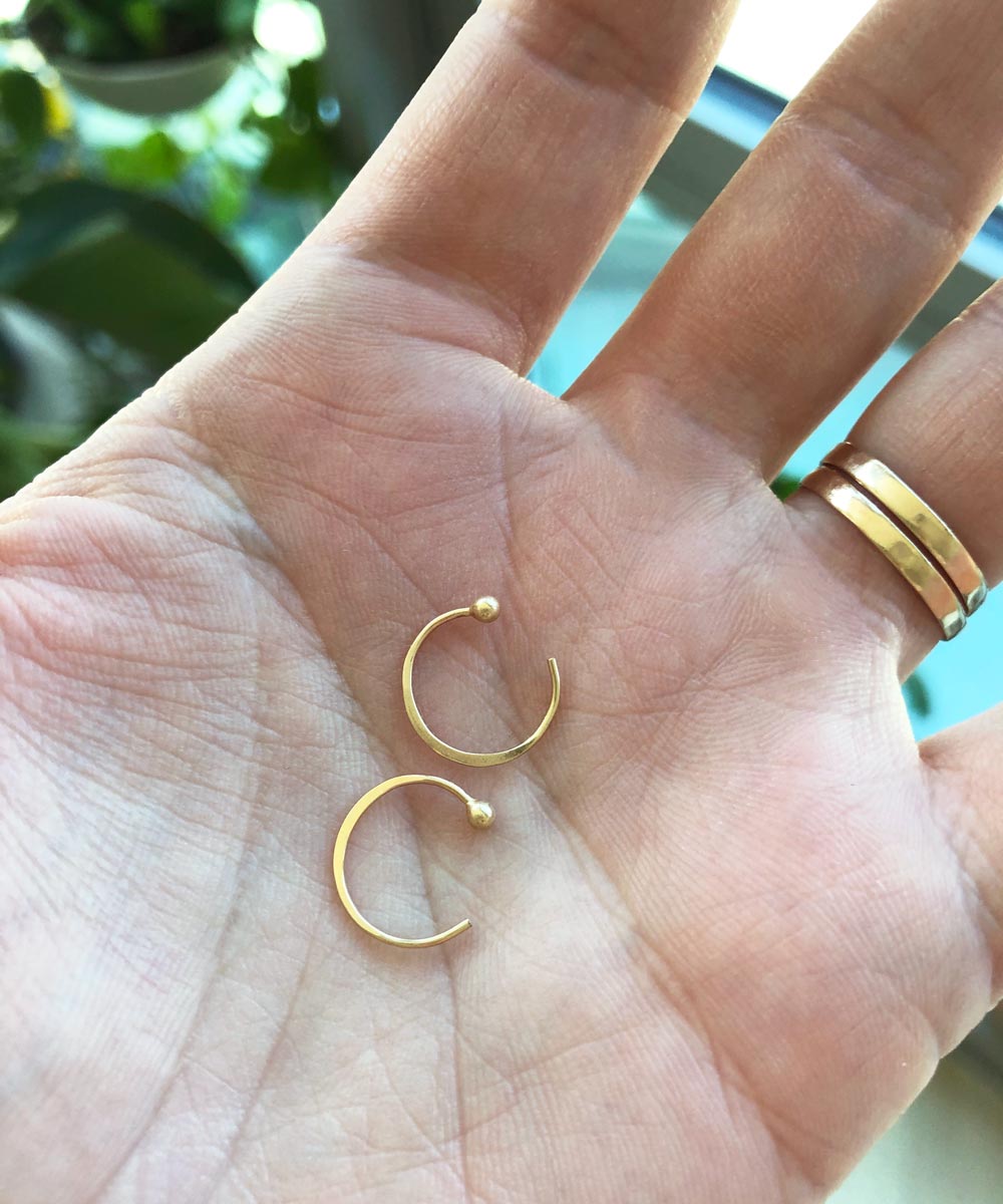 tiny gold ball end hug hoops in hand