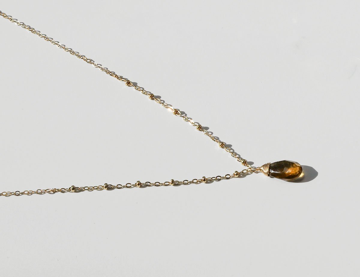 side view of beer quartz and gold pendant necklace