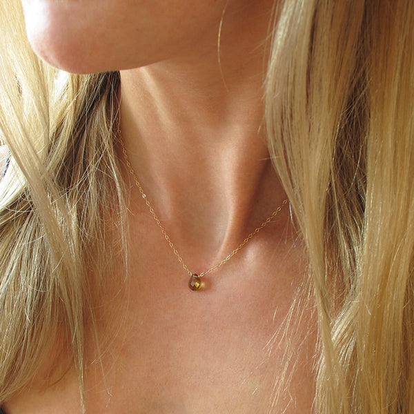 blond woman neck closeup wearing a 14k gold filled beer quartz short gemstone necklace