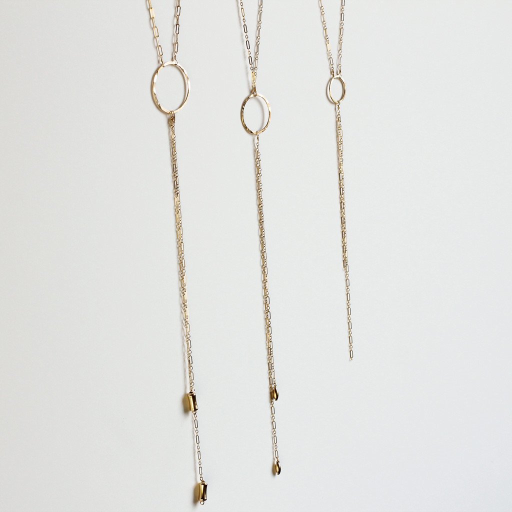 three gold y shaped necklaces with circles "bolo necklaces" by delia langan jewelry