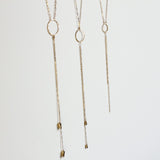 three gold y shaped necklaces with circles "bolo necklaces" by delia langan jewelry