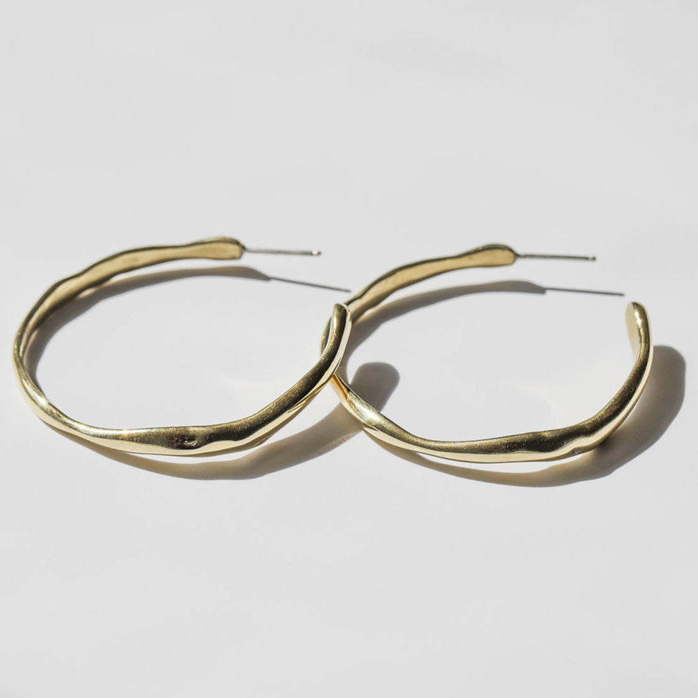 pair of gold irregular post back hoop earrings