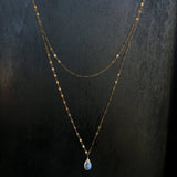 14k gold filled moonstone choker wrap gemstone necklace on a black wood surface