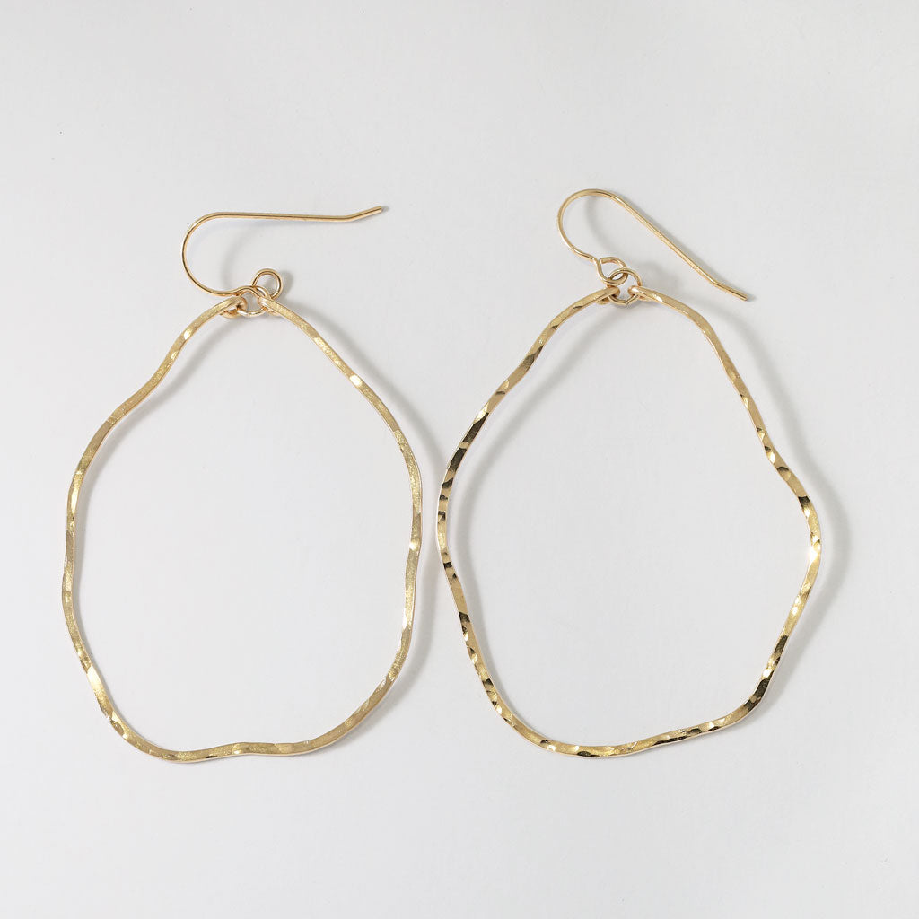 14k gold filled potatohead hoop earrings on a grey surface