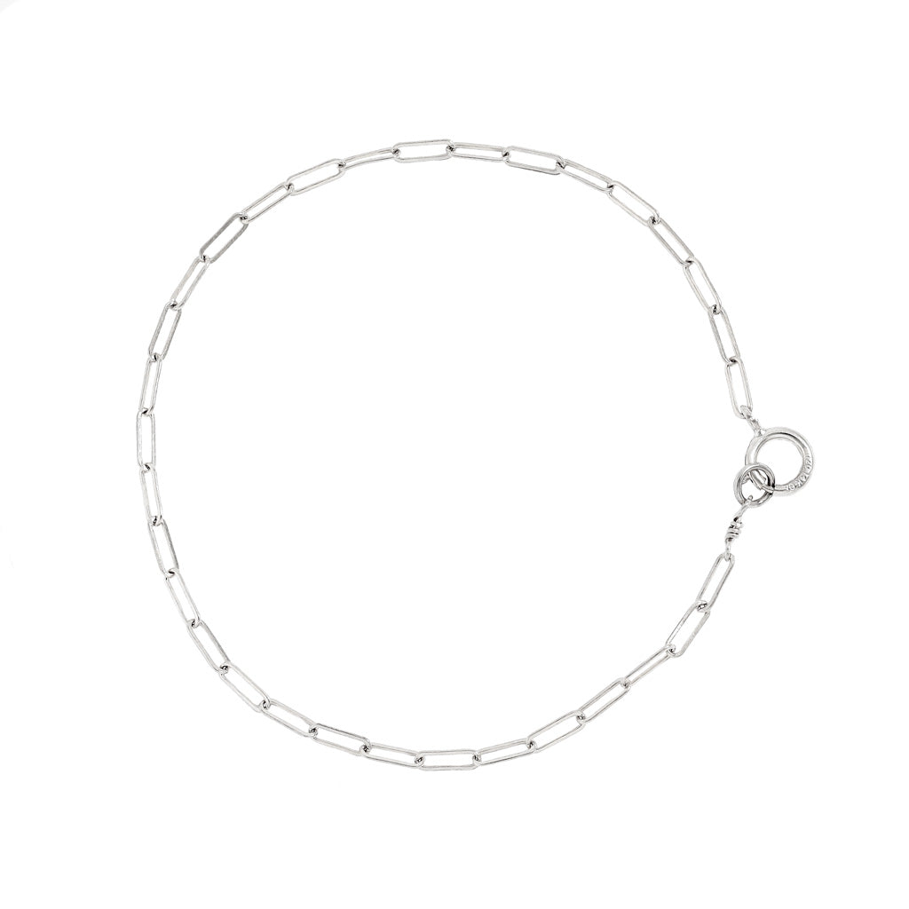 sterling silver small link chain bracelet on white surface