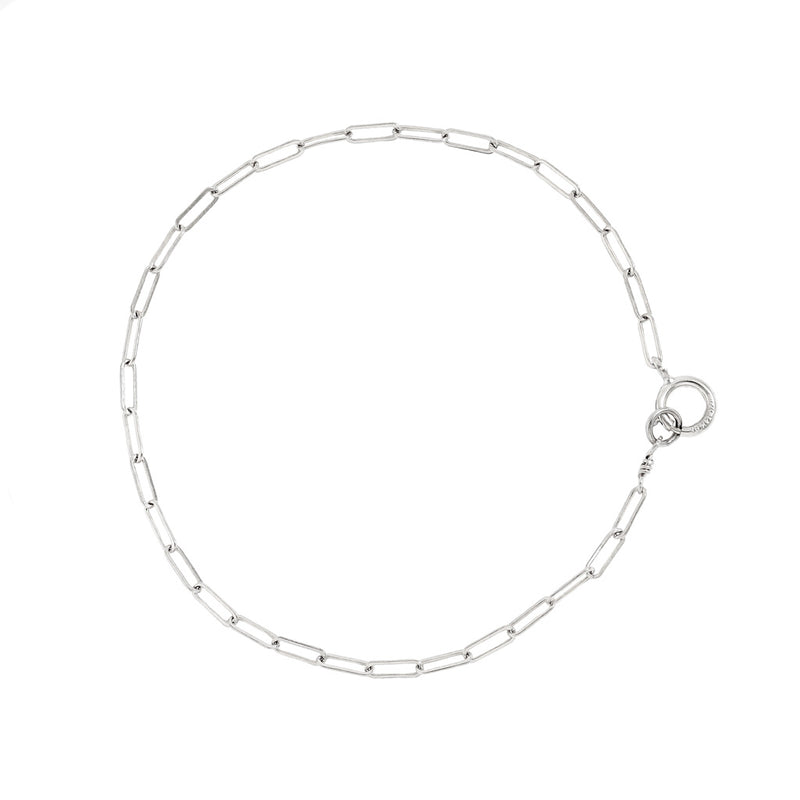 sterling silver small link chain bracelet on white surface