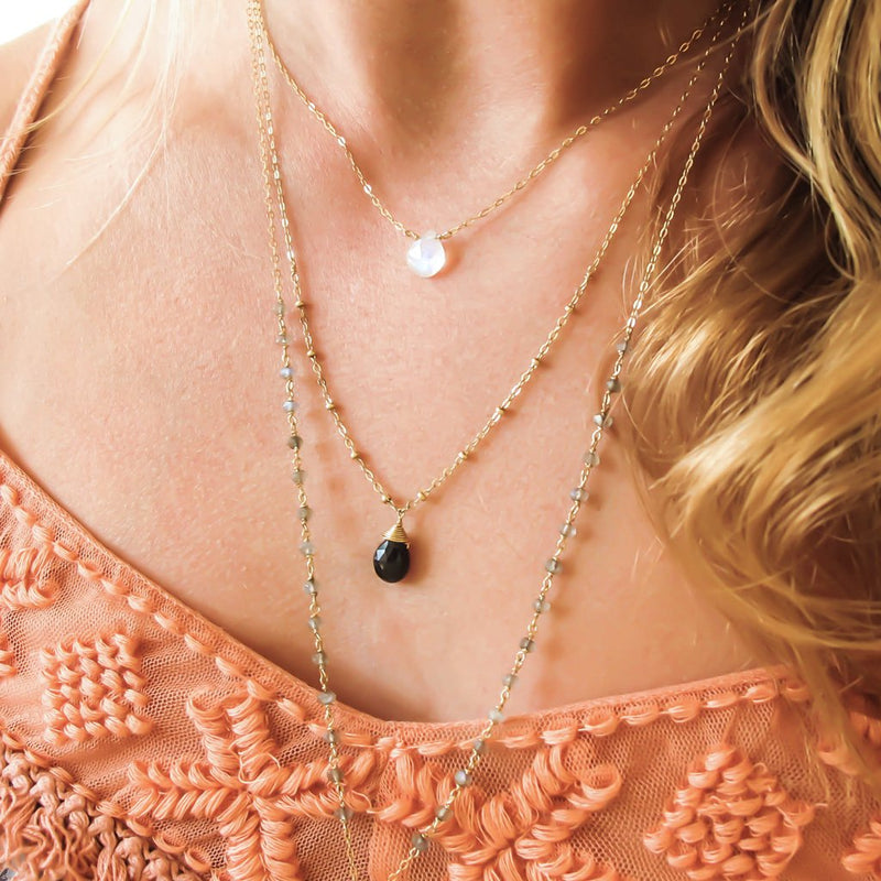 layered gold chain necklaces with moonstone black spinel and labradorite by delia langan jewelry