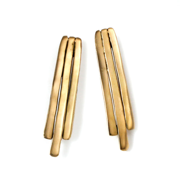 gold brass small fringe post earrings on white surface