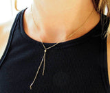 delicate gold y necklace tied up pendant by delia langan jewelry