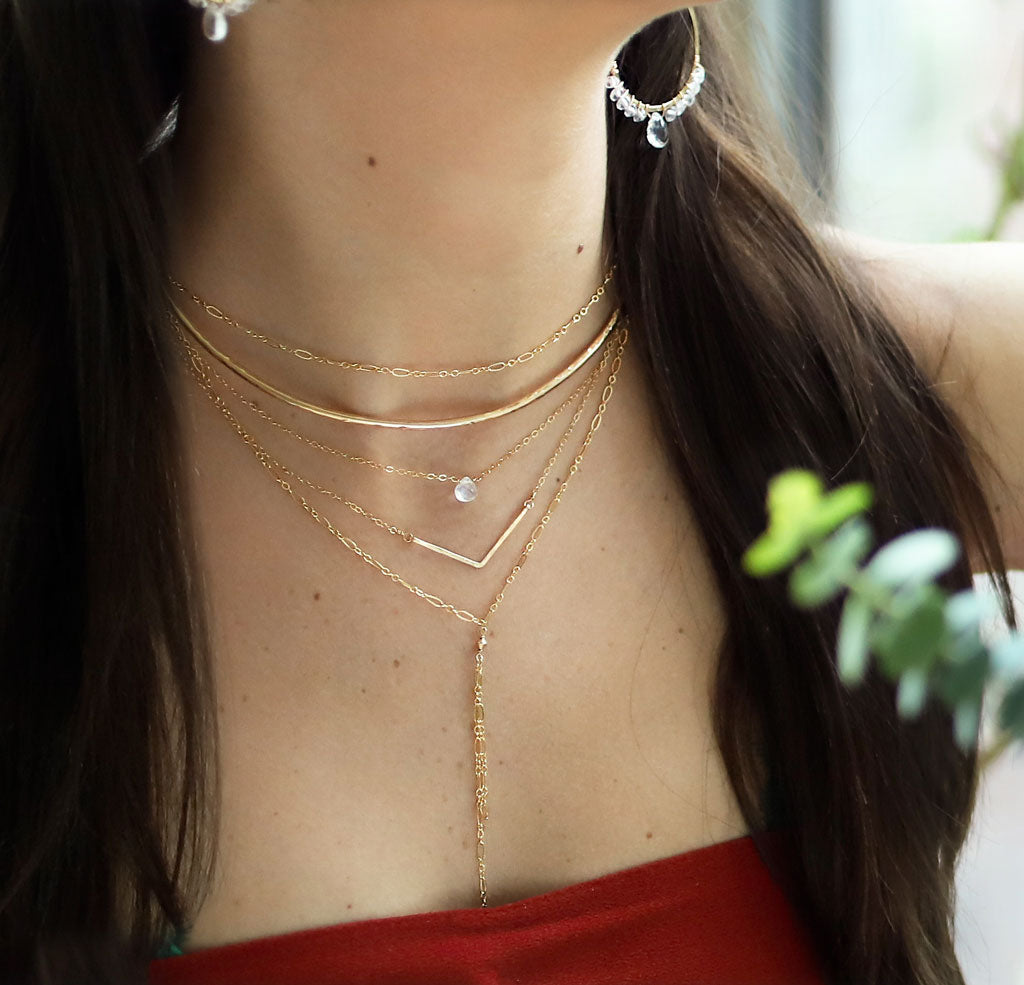 brunette on a red top wearing a 14k gold filled moonstone short gemstone necklace
