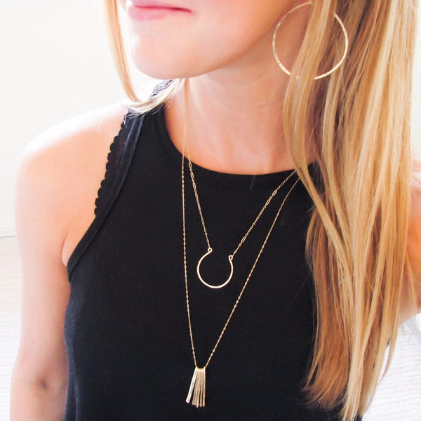 blond woman on a black tank wearing a 14k gold filled xl good luck necklace