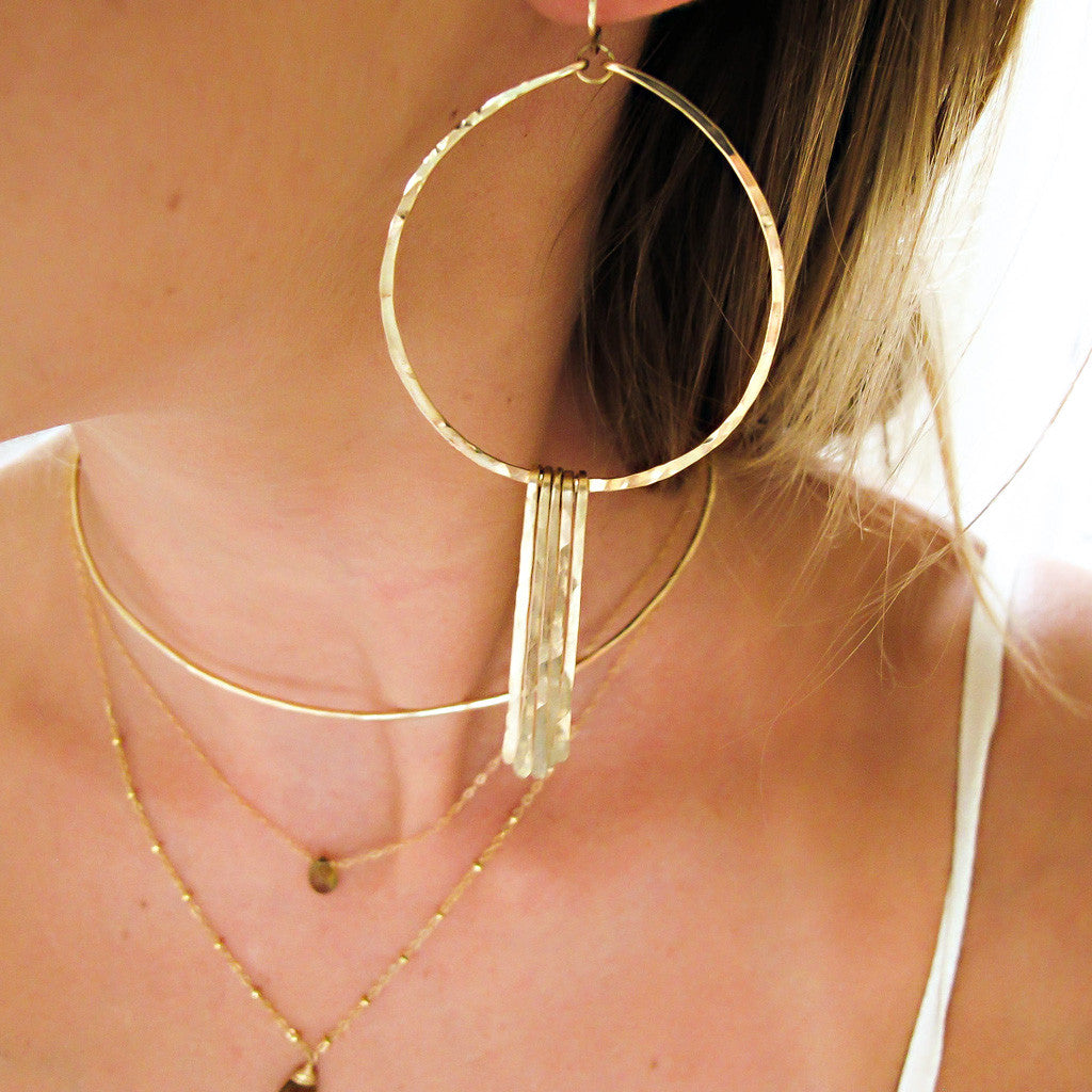 blond woman ear closeup wearing 14k gold filled xl round fringe hoops