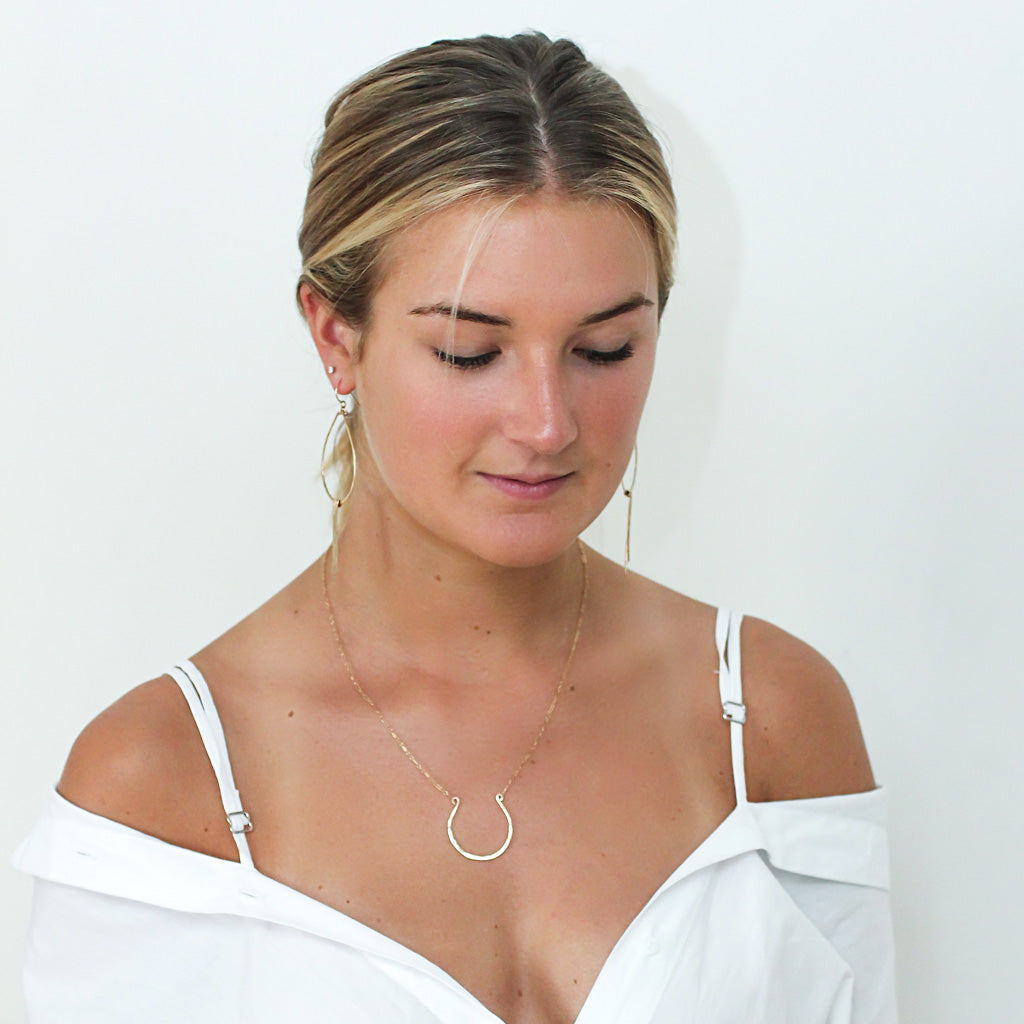 gold horseshoe necklace by delia langan jewelry