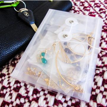 picture of jewelry packaged in an envelope so that it doesn't tangle during travel - how to safely transport delicate jewelry