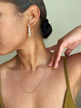 womans profile and neckline with pearl drops and delicate gold rope chain