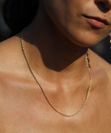 gold rope chain necklace on neck