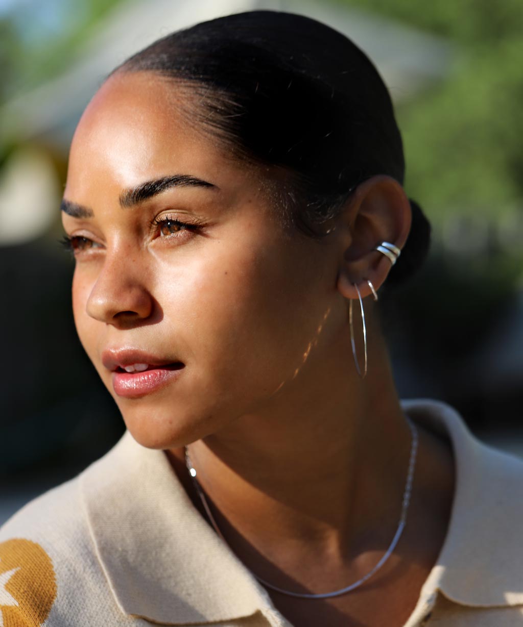 girl with 4 layered silver hoop earrings