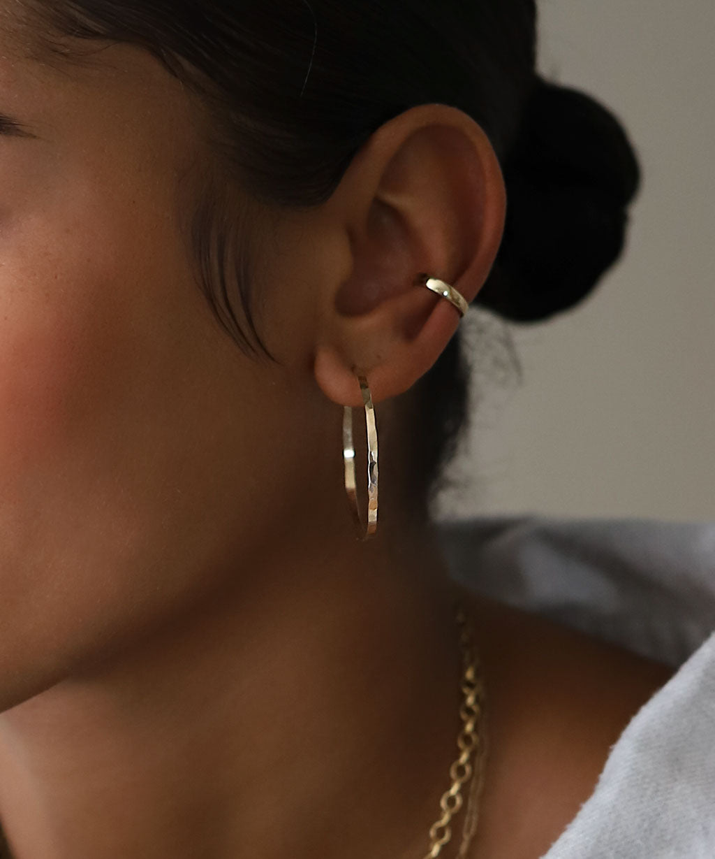 ear with hammered 1.5 inch gold hoop and simple gold ear cuff