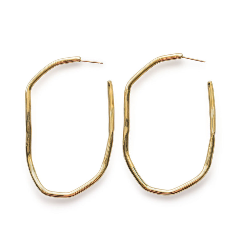 extra large irregular gold long hoop earrings against white background