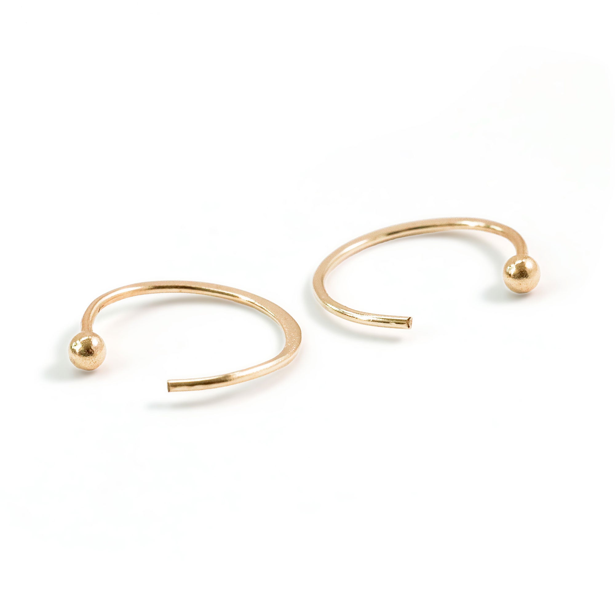 tiny gold ball end hug hoops on white background