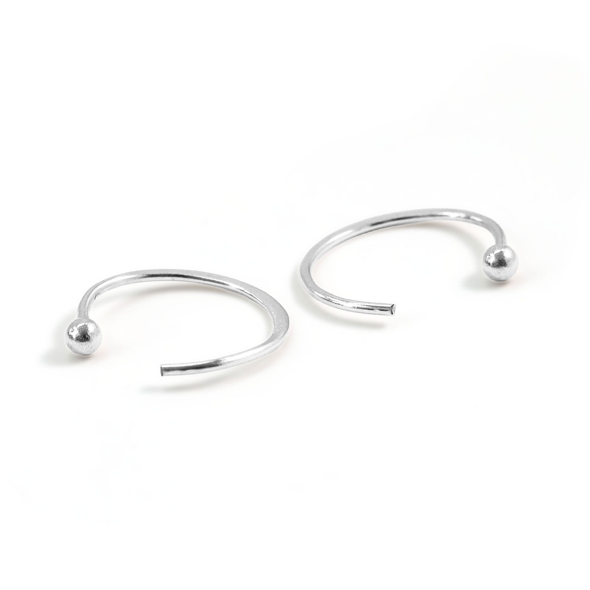 tiny sterling silver ball end hug hoops on white background