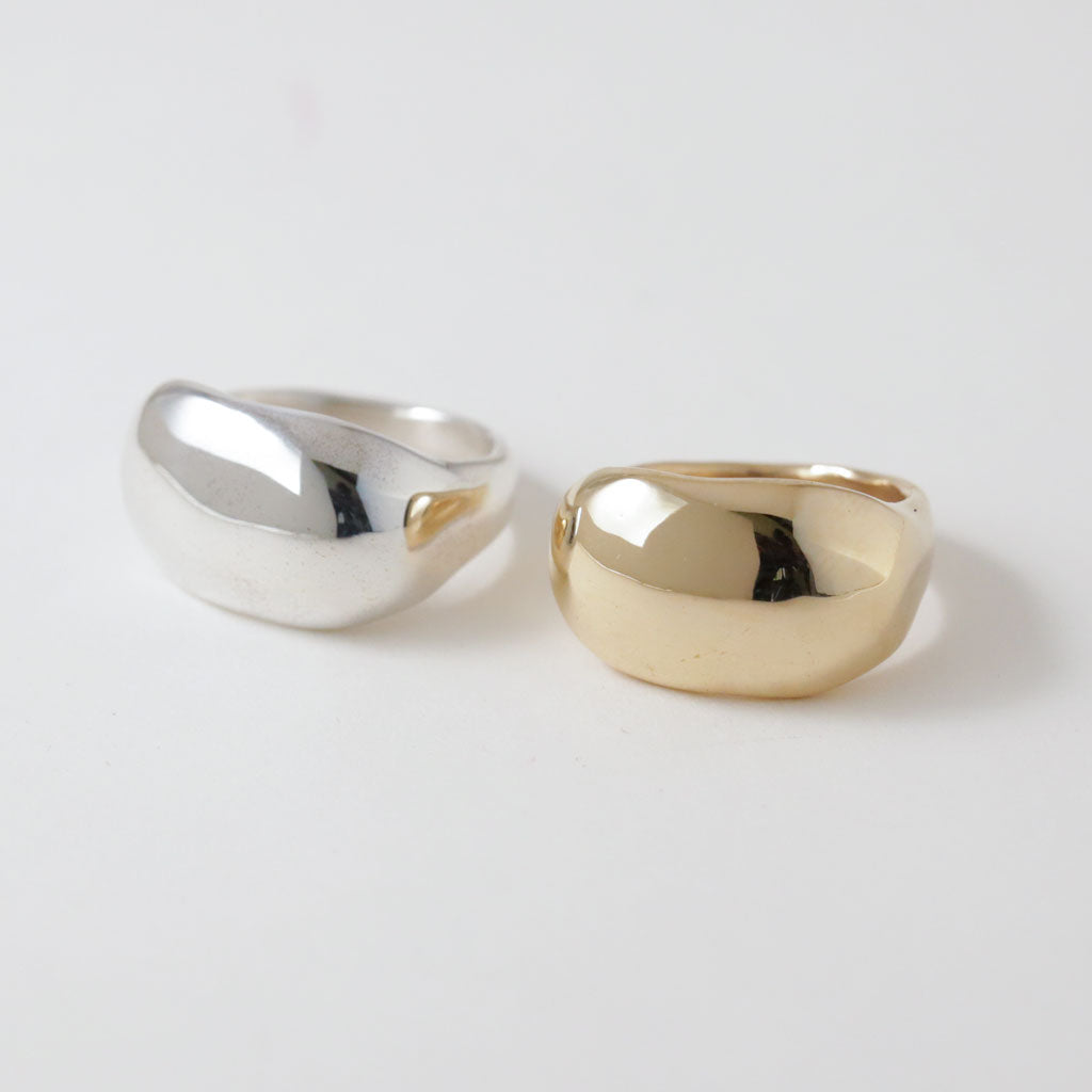 two gold and silver rings on pale gray background