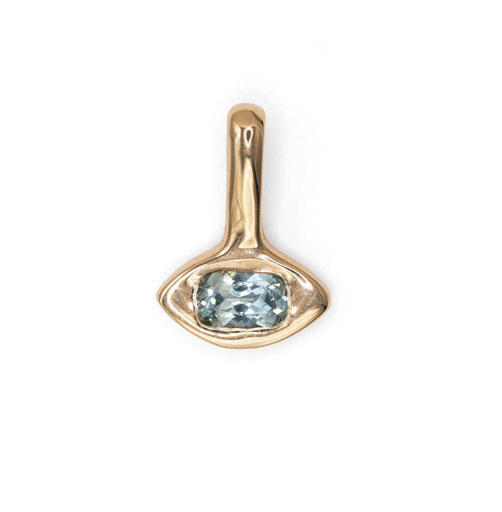 gold amulet-shaped pendant with a cushion-cut blue sapphire