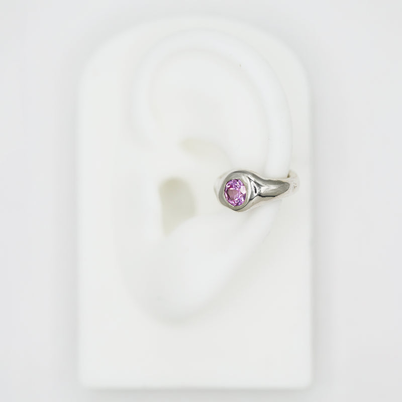 silver ear cuff with pink sapphire gemstone on fake ear