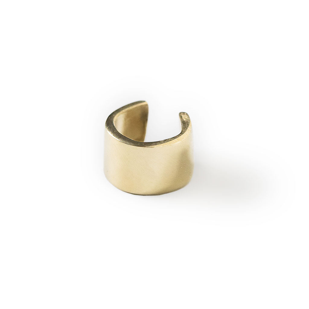 gold colored wide cartilage hug hoop on white background