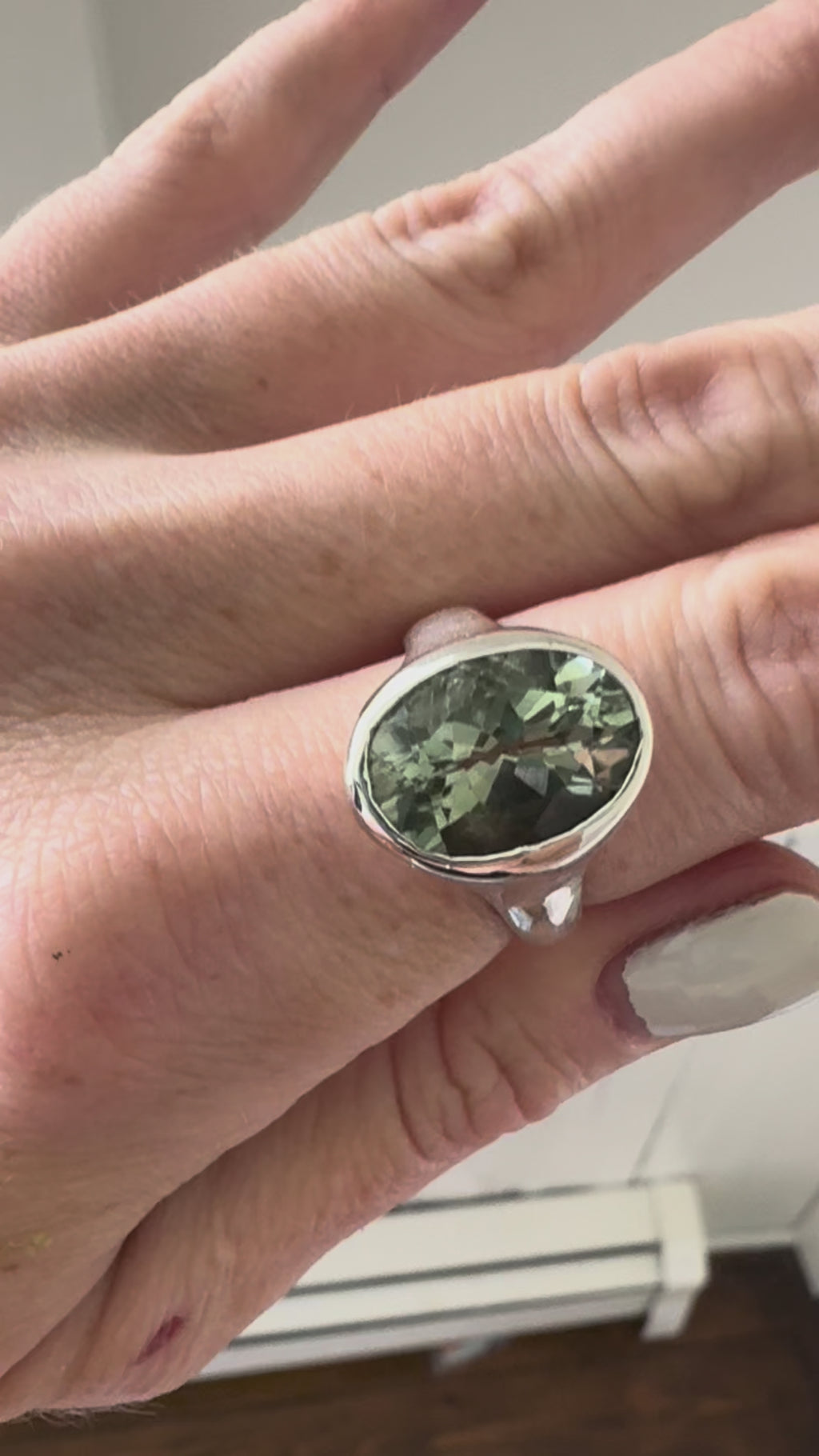 video of hand with green amethyst and silver ring