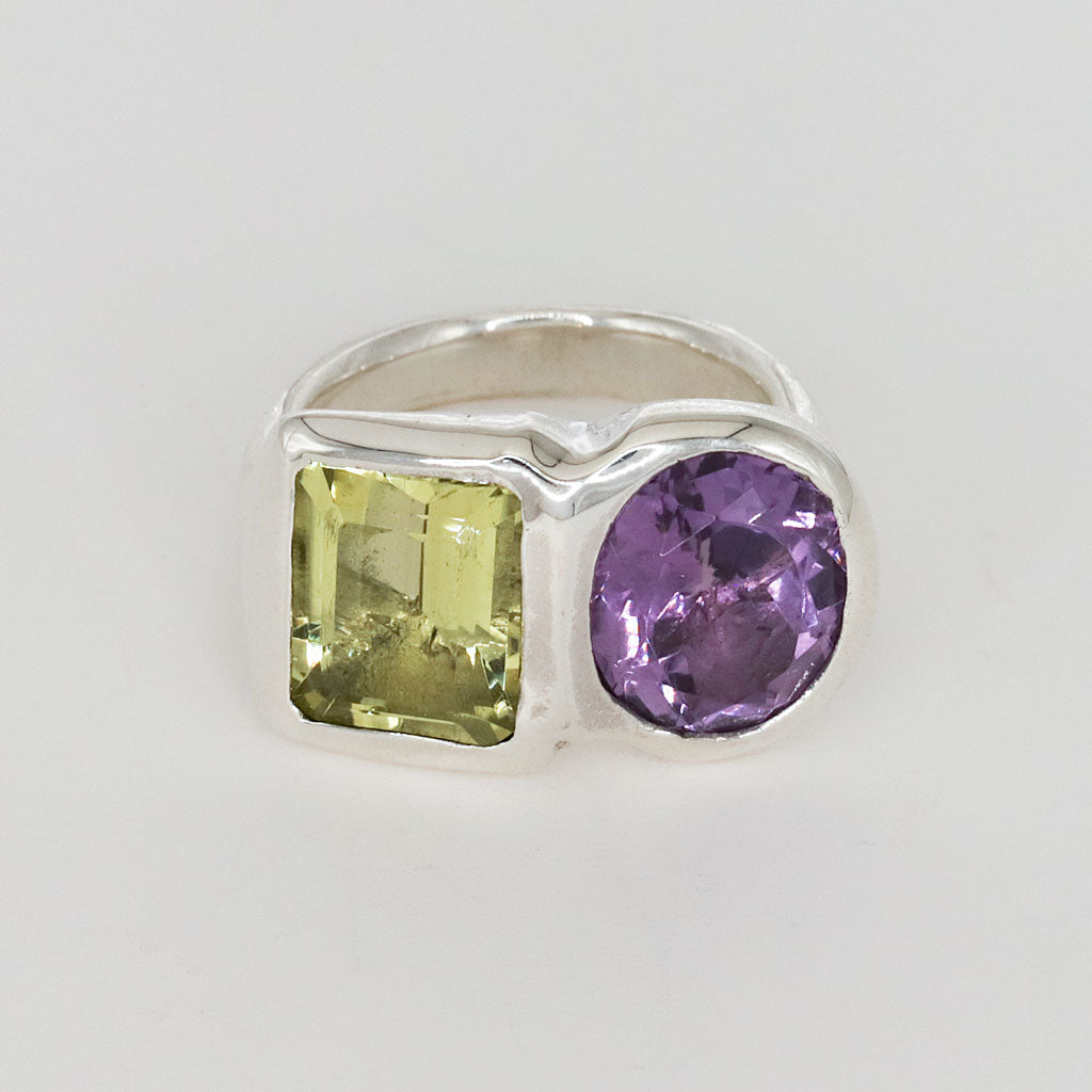 silver ring with yellow and purple gemstones