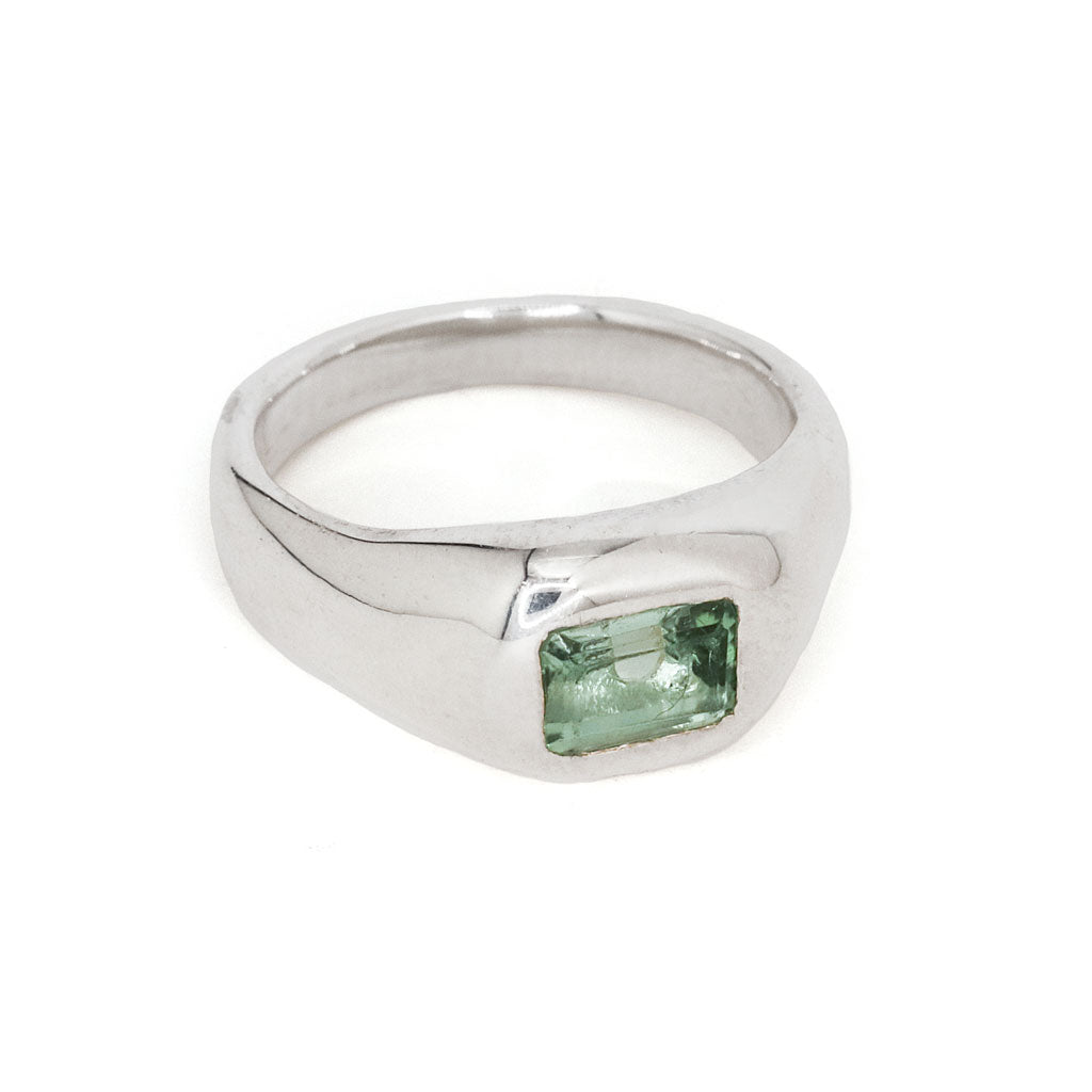 mint green tourmaline and silver ring on white background