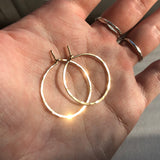 1" diameter thin gold hoop earrings in hand