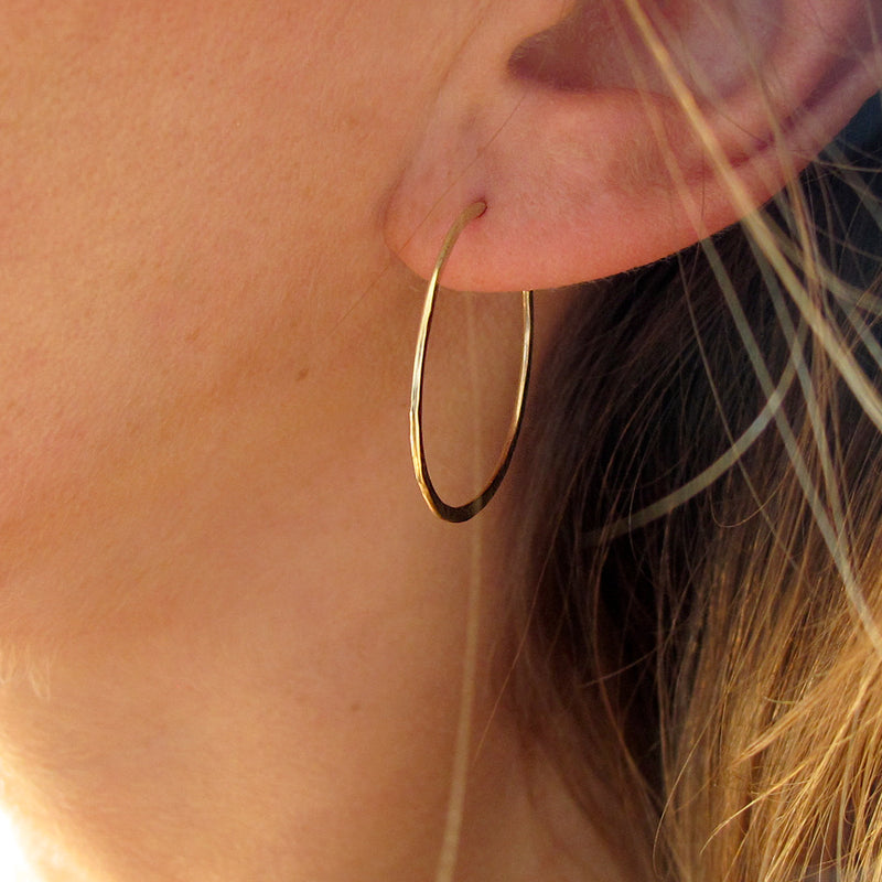 1" diameter thin gold hoop earrings on ear