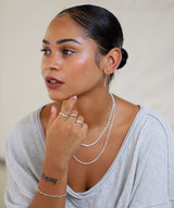 girl with layered sterling silver rings and chain necklaces and bracelet