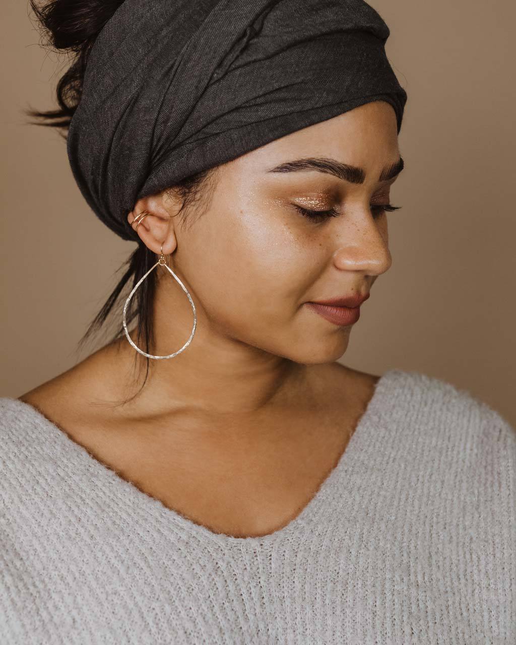 large delicate teardrop hoop earrings on alyssa redenti with hair wrap