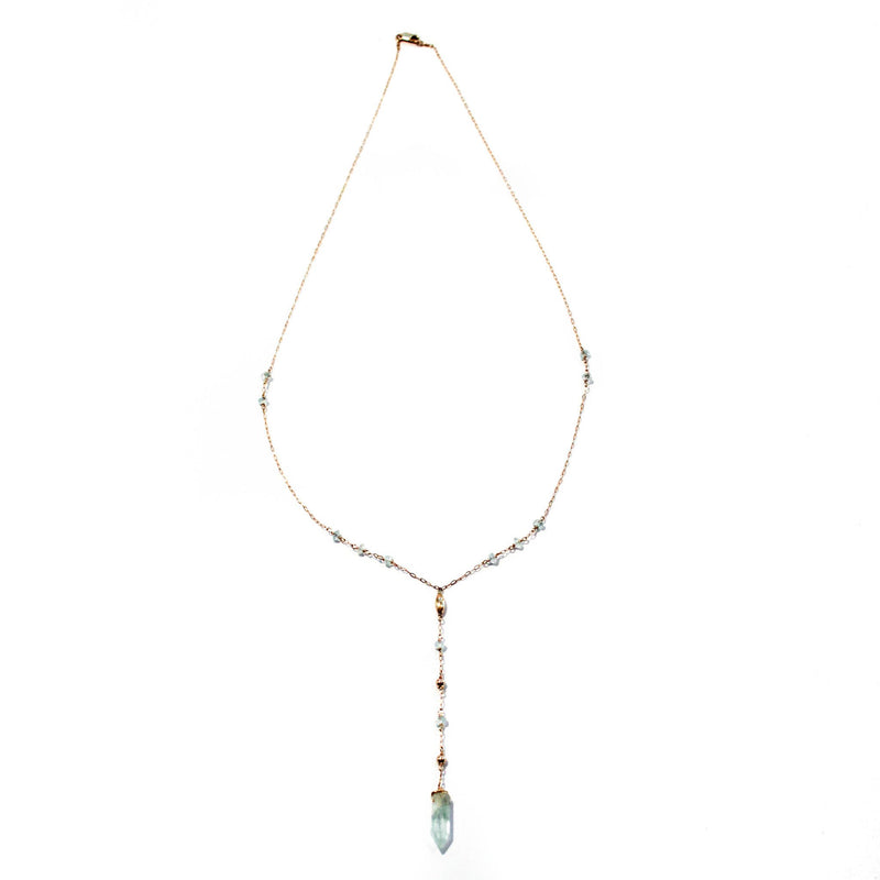 14k gold filled aquamarine y gemstone necklace on a white surface