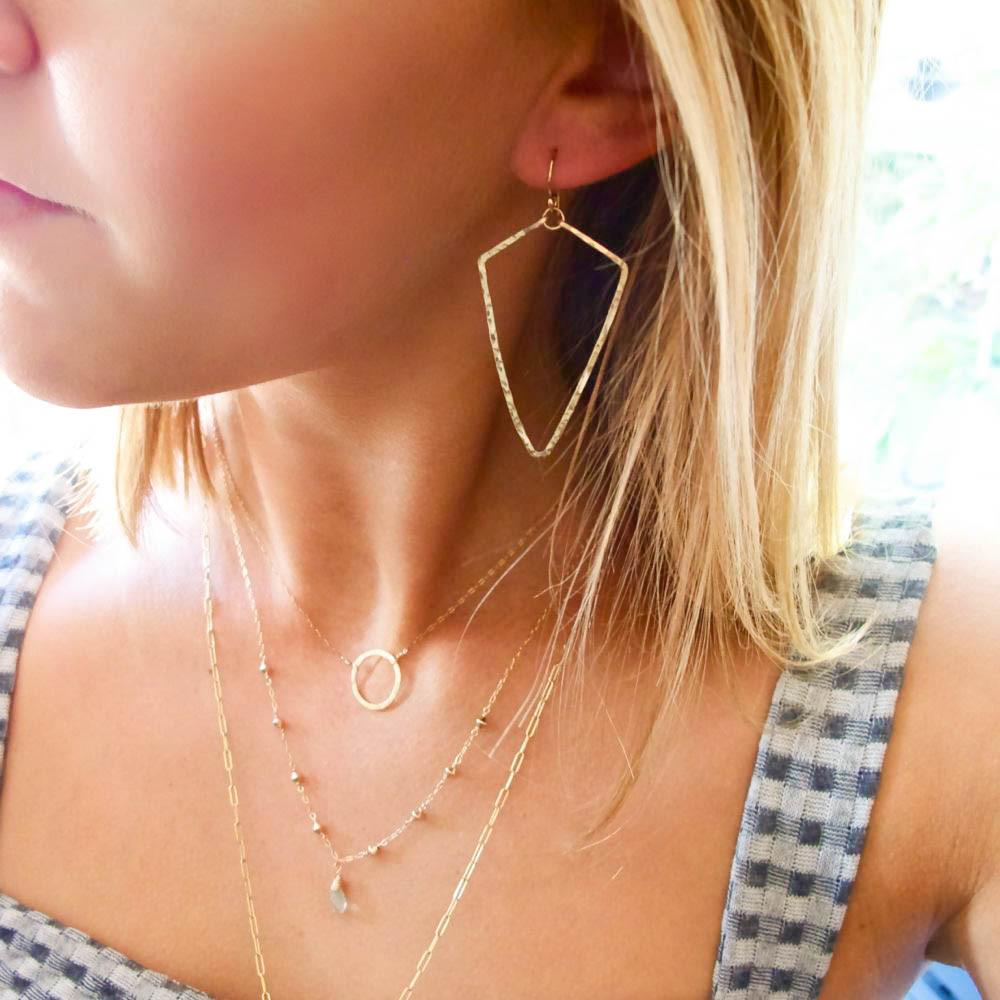 gold arrowhead earrings delicate geometric hammered earrings by delia langan jewelry