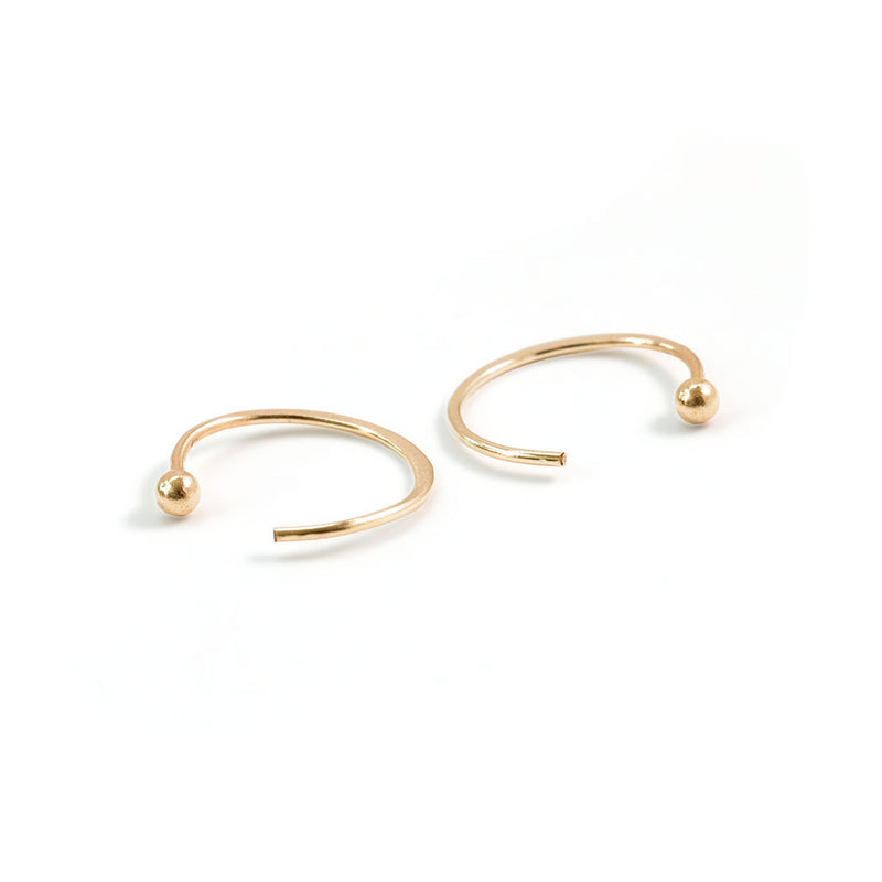 tiny gold ball end hug hoops on white background