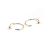 tiny gold ball end hug hoops on white background